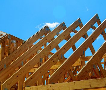 wooden roof construction, symbolic photo for home, house building, and house financing